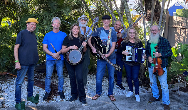 8-member band "Smokeboss Militia" holding instruments against thick palm foliage background.