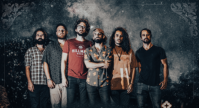 6 members of the band "Joey Calderaio Band" posed against a dramatic night sky.