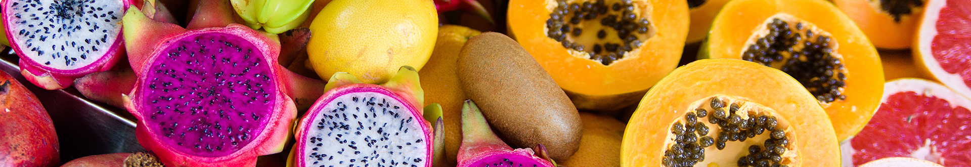 Close-up of colorful cut fruits including passion fruit, cantaloupes, kiwi, starfruit and grapefruit.