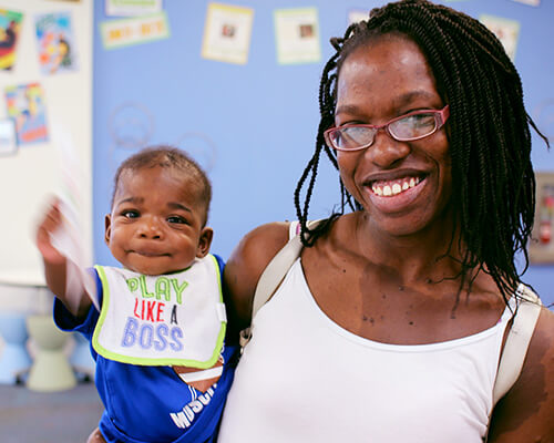 Mother and young child waving