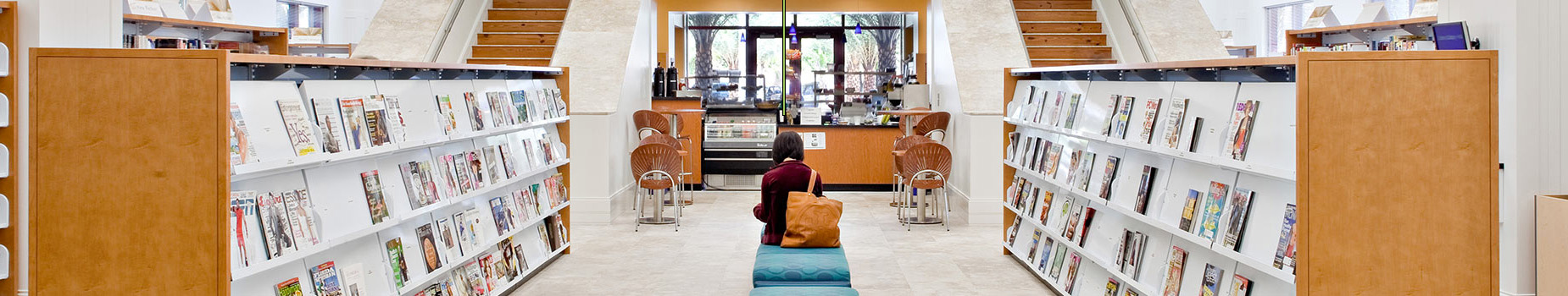 Cafe and magazine racks with reading figure in the center