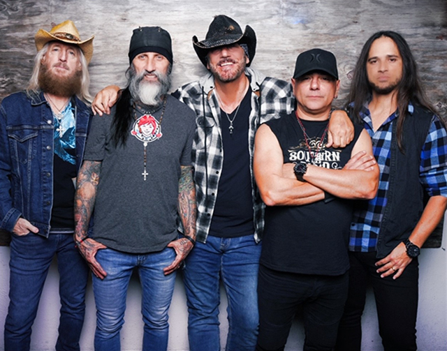 Five male members of the Southern Blood band standing side-by-side against a wood panel background