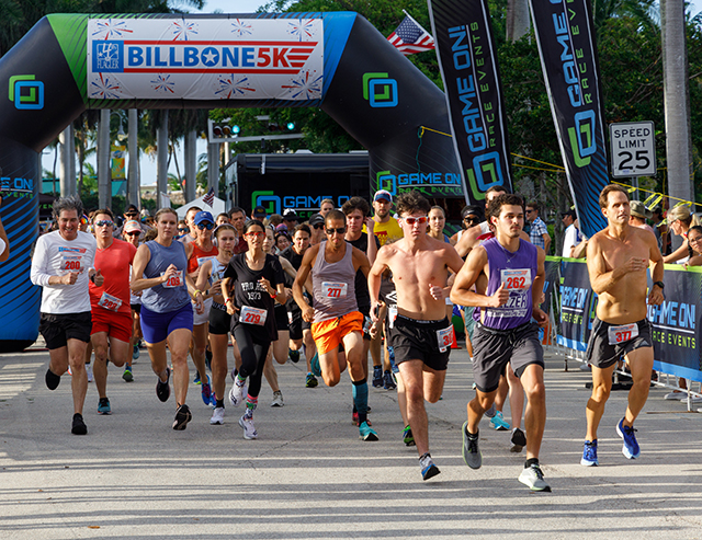 Image of many runners leaving the starting gate at the Bill Bone 5K Race at 4th on Flagler, 2022