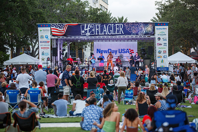 4th of July crowd spread out on the lawn in front of the NewDay USA Stage