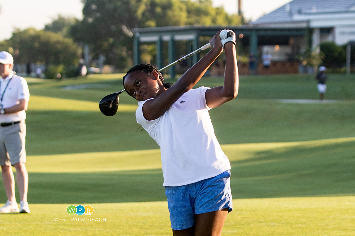 Alana Hall, Boca Raton, follows through on her drive on the first tee.