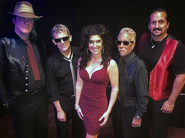 Photo of 5-Member Band On The Roxx, all dressed in formal wear, standing against black background.