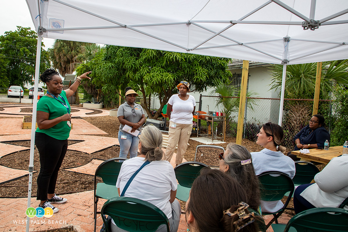 Opening ceremonies for the Pleasant City Community Garden. Photo shows speakers with audience.