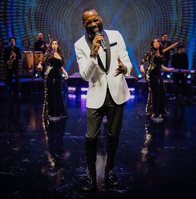 Vocalists and musicians of the St. Royal Band performing on stage.