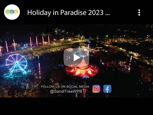 Youtube Graphic featuring aerial view of Holiday in Paradise event site at night, with Sandi the Holiday Tree and the Ferris Wheel surrounded by crowds of festival-goers.