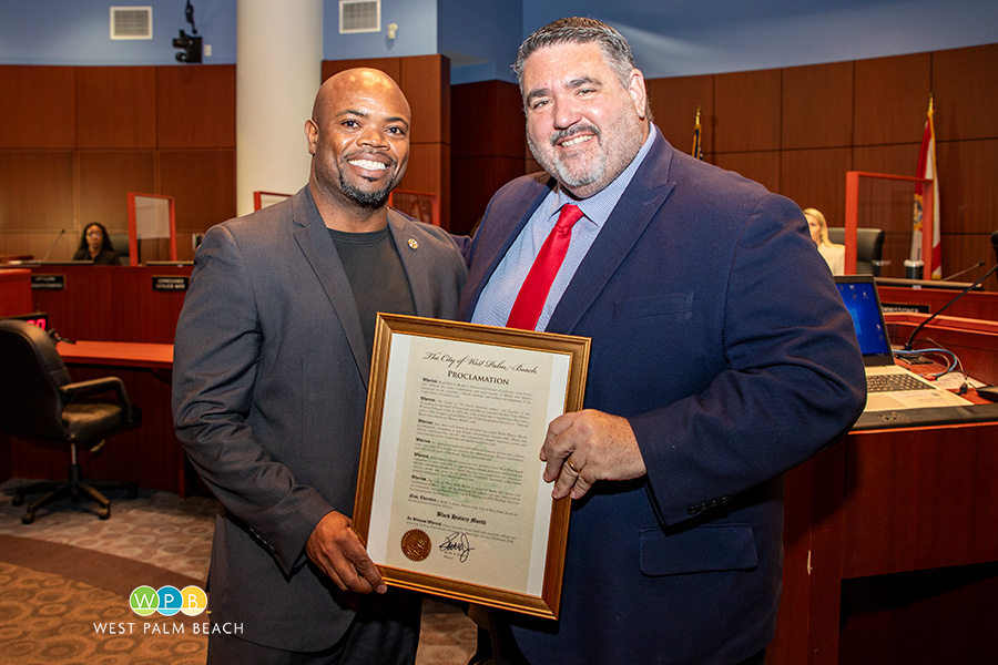 City Commissioner Joe Peduzzi presents to Owen Robinson City Commissioner Joe Peduzzi presents to Owen Robinson - a