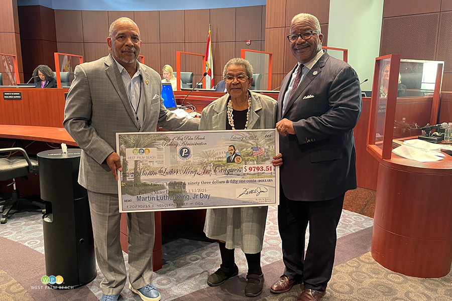 Ed Davis, left, and Mayor Keith A. James, present a check to Edith Coleman Bush, MLK Caregivers - a