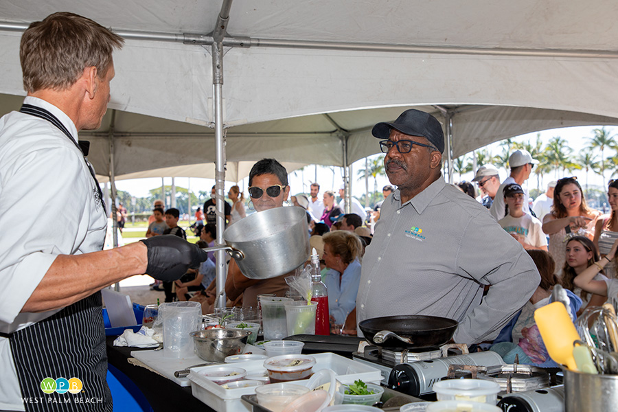 Chef Joey Leuze offers cooking advice to the Mayor - a