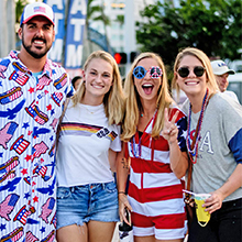 Photo of happy 4th on Flagler attendees in patriotic attire, smiling at the viewer