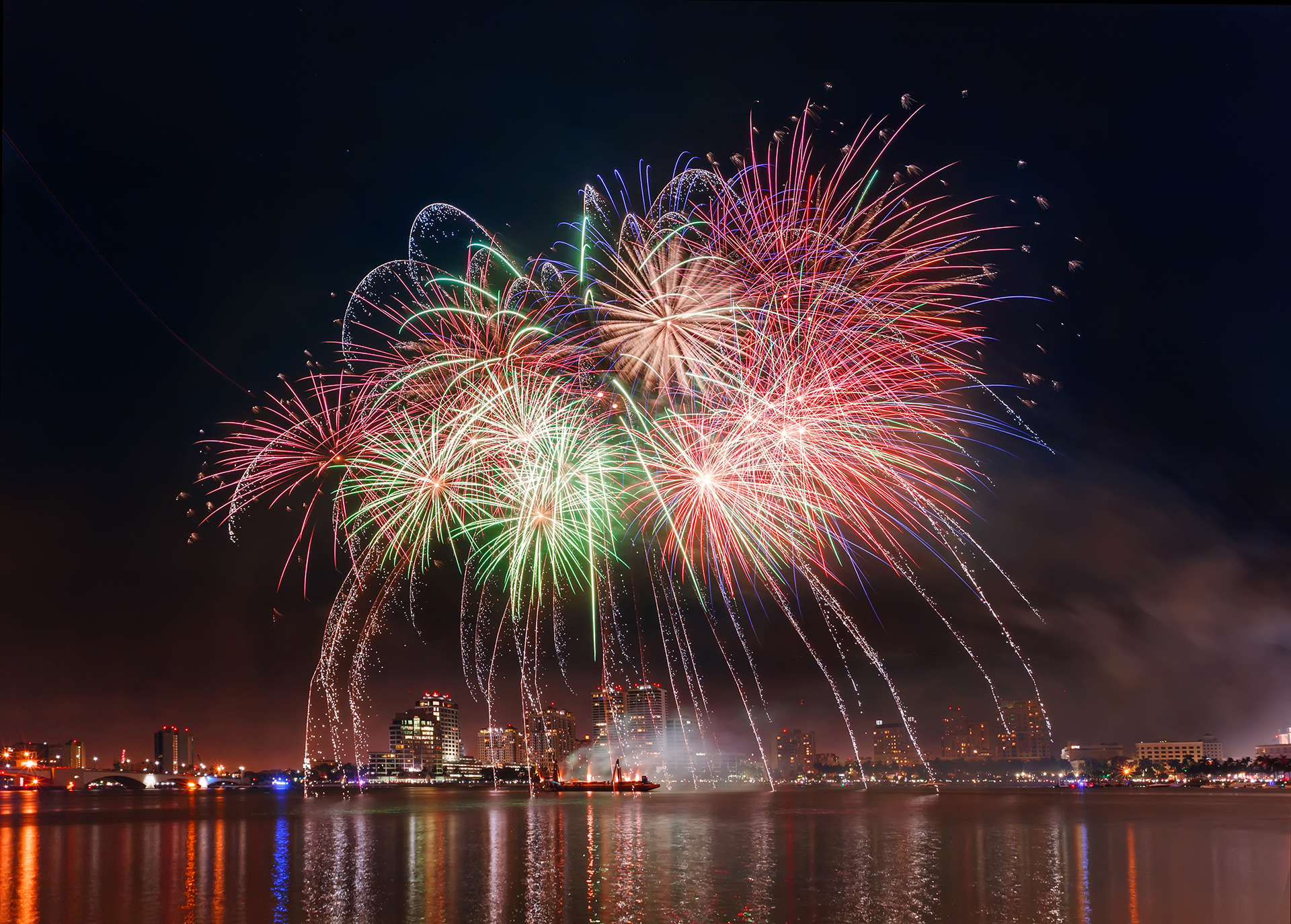 Spectacular fireworks detonating over the West Palm Beach Waterfront, taken from across the Intracoastal Waterway, West Palm Beach, Florida