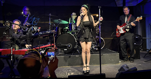 Image of Female Performer from "Stronger Than Me" band, an Amy Winehouse Tribute, performing on stage.