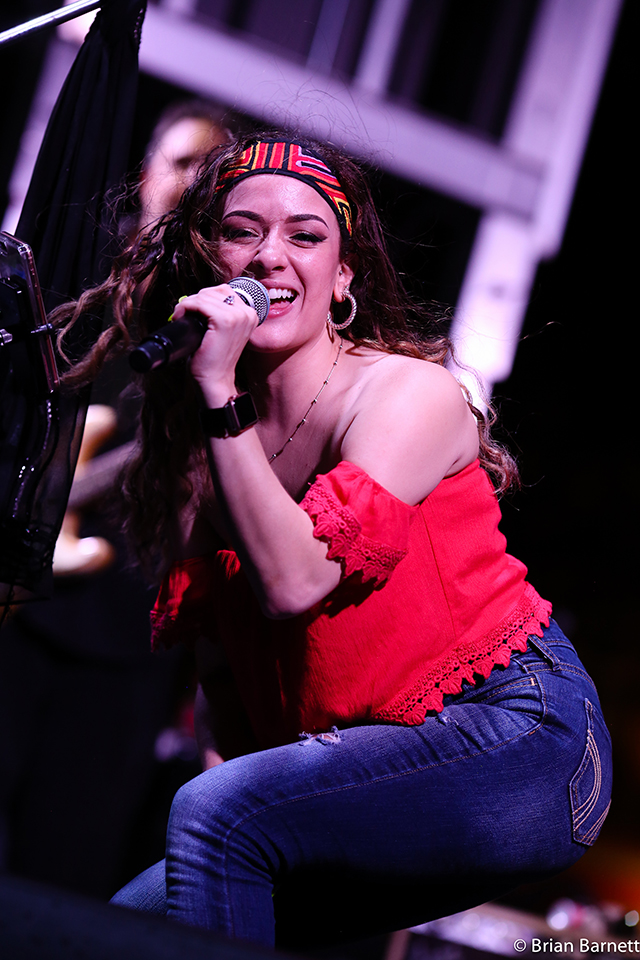 Melinda Elena singing, onstage