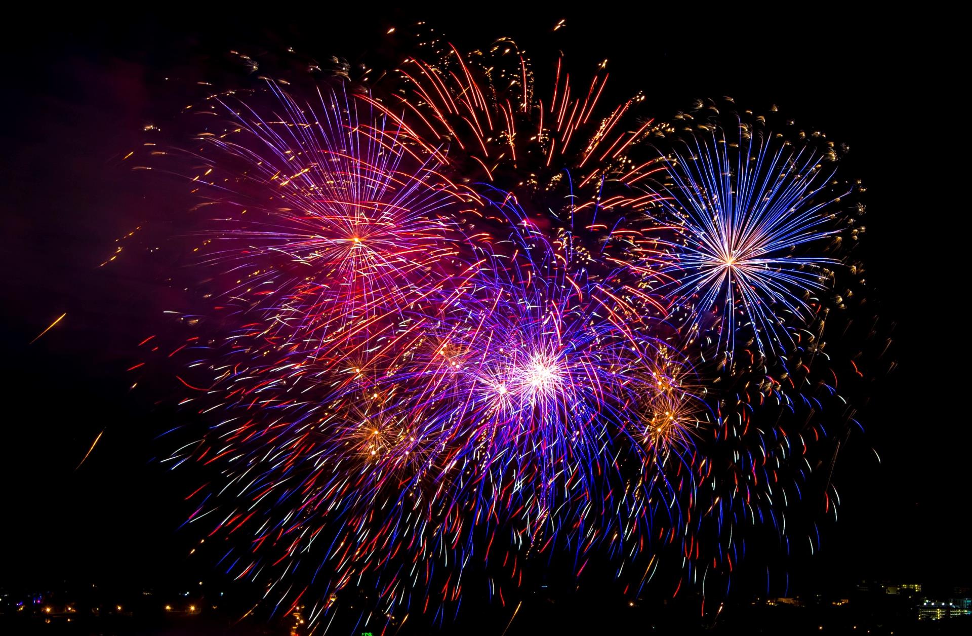 A photo of fireworks in a dark sky