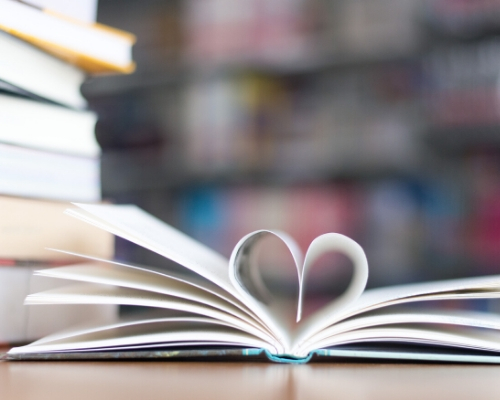 open book with pages forming a heart