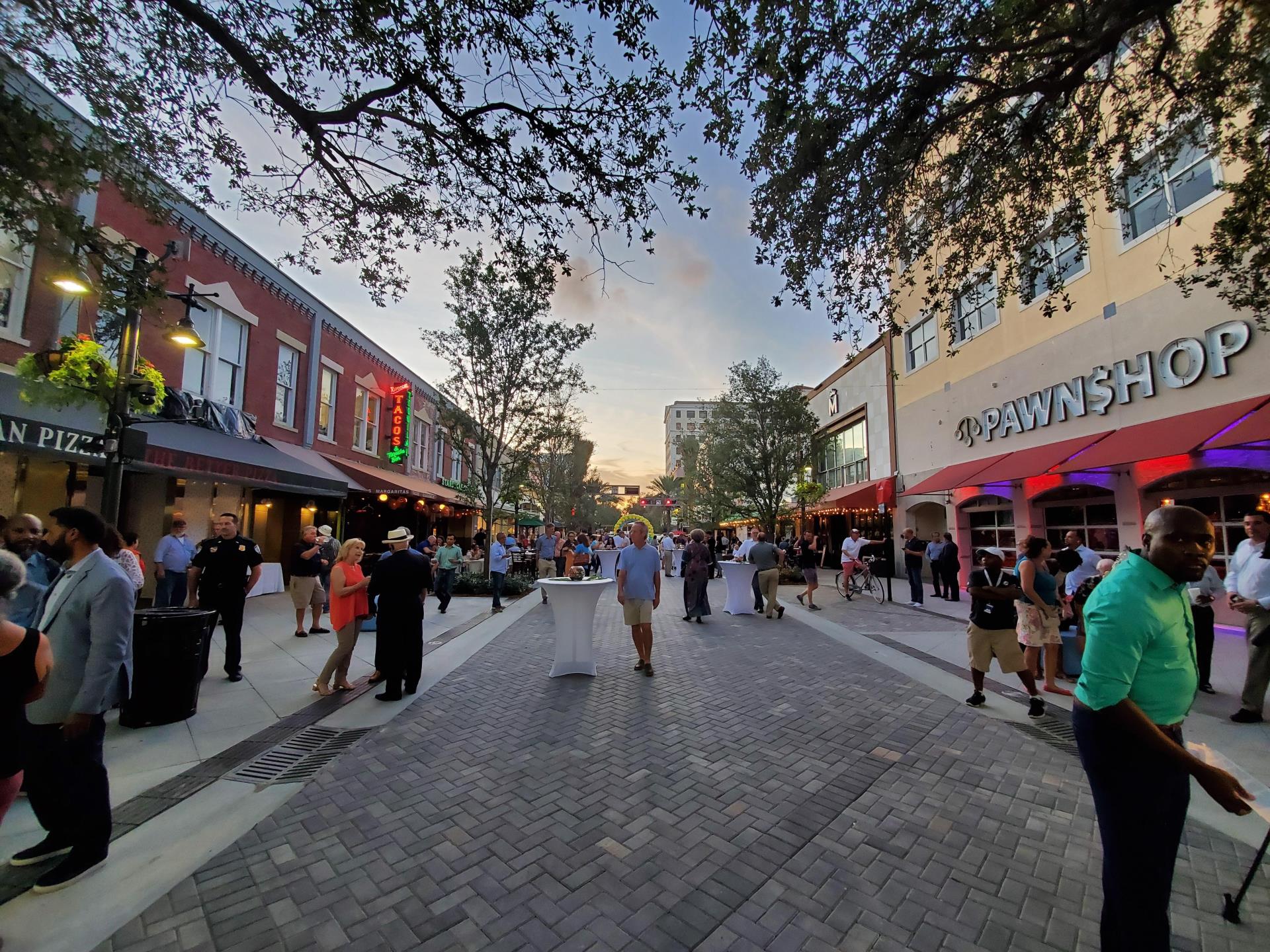 People gather on Clematis at sundown to celebrate the street's reopening, November 7, 2019