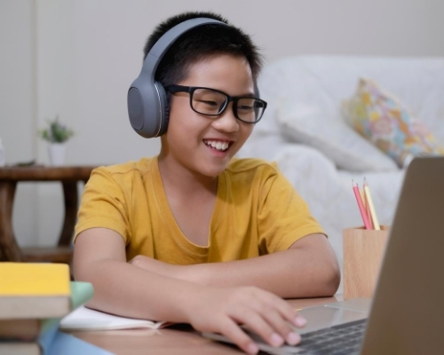 Child on computer smiling