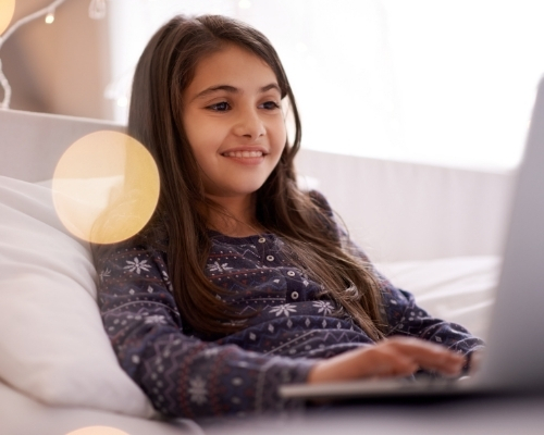 Smiling tween girl on computer