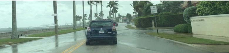 Car driving through a flooded section of Flagler