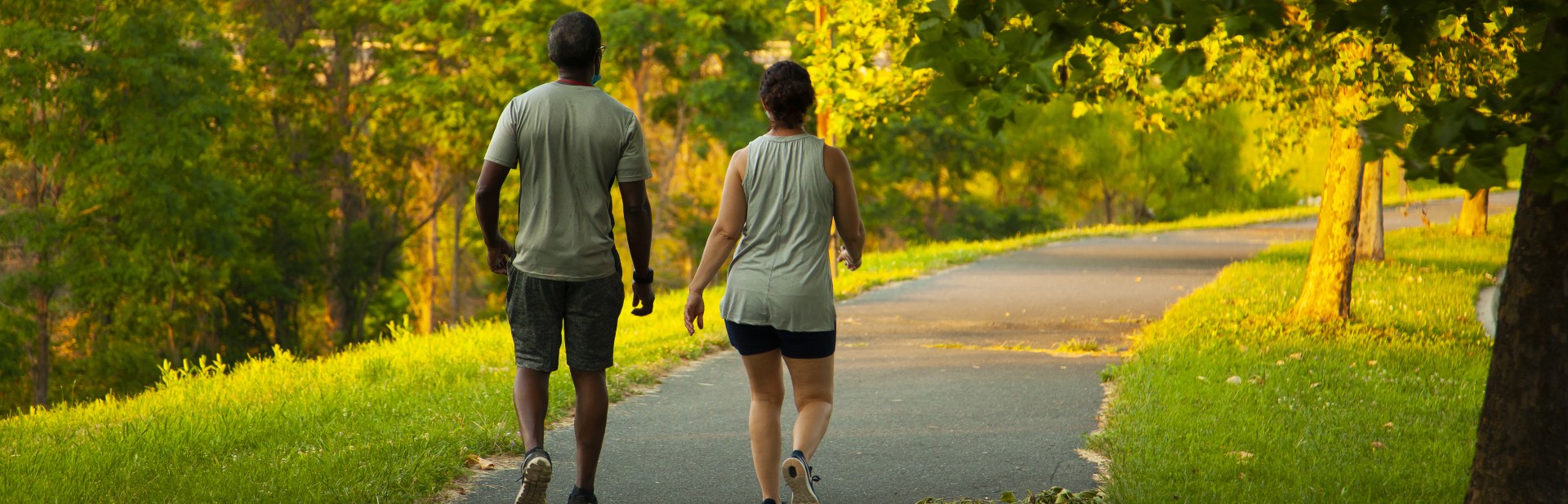 Couple walking along a wooded trail