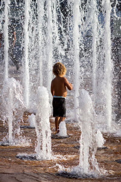 Photo of a boy playing in Centennial Square Fountain