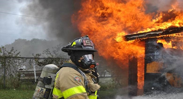 Firefighter in front of burning building