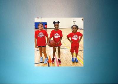 Three girls about to play basketball