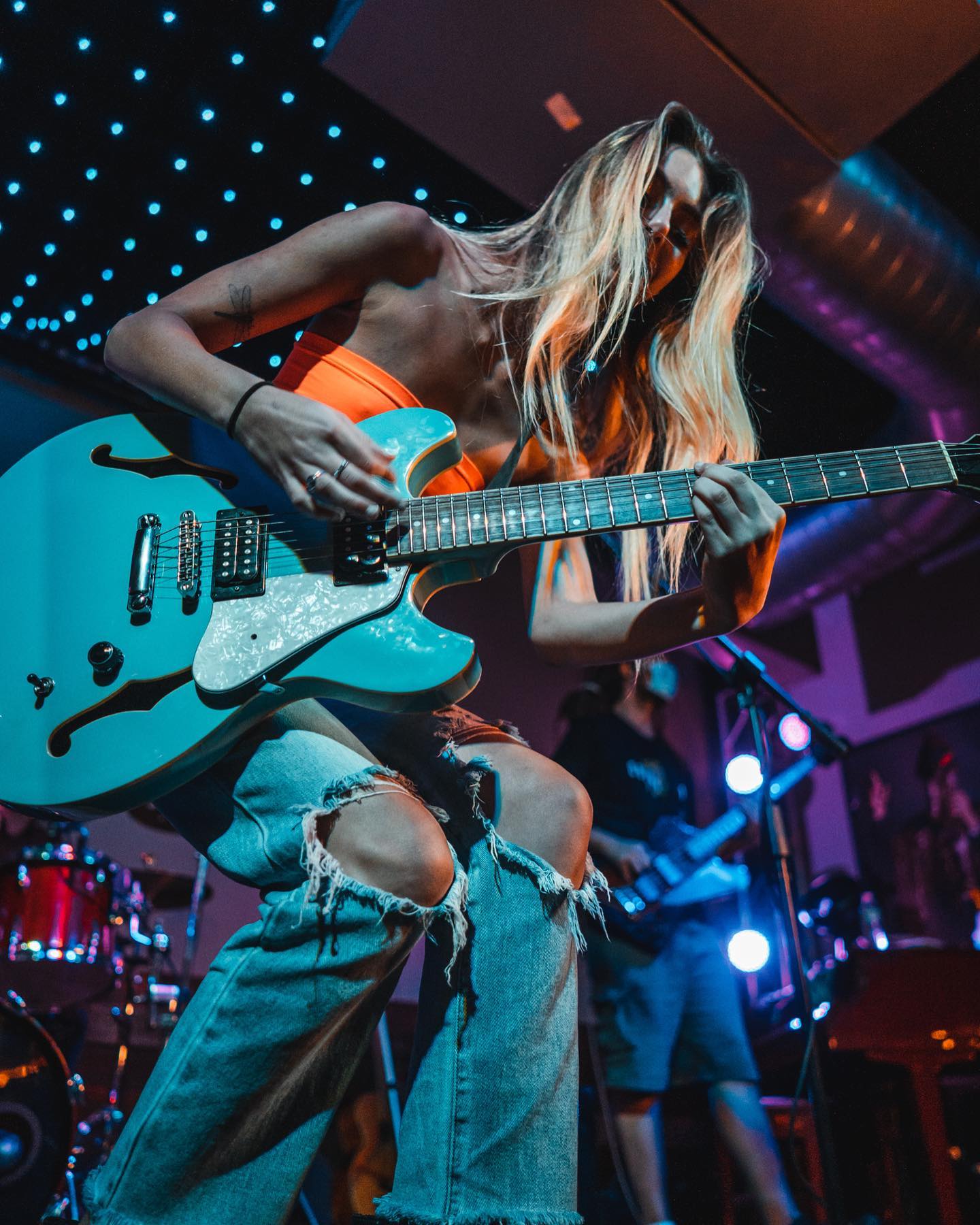 Photo of Sierra Lane playing a guitar