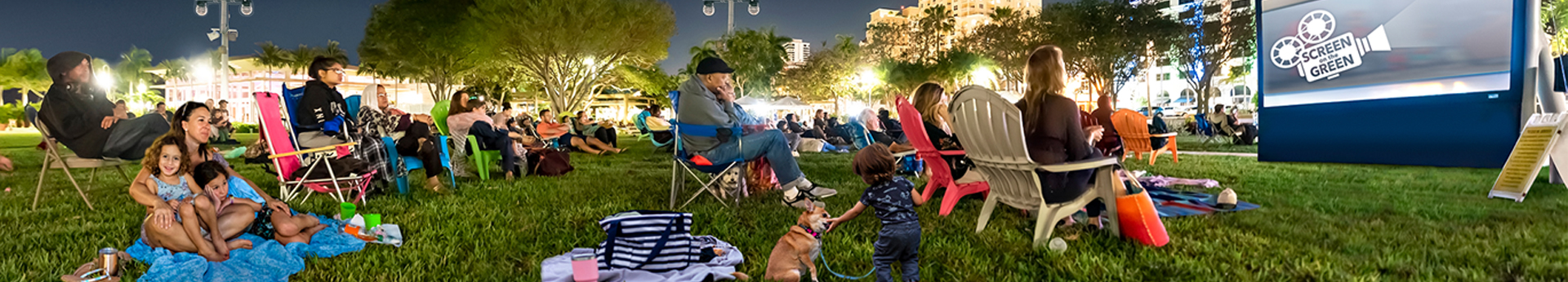 Photo of patrons relax on the Great Lawn at Screen on the Green under the stars to watch the outdoor movie.