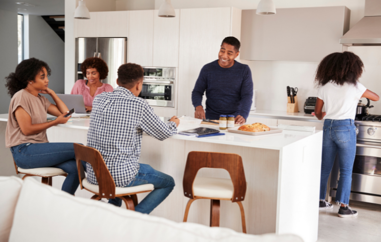 Photo of minority family around kitchen island