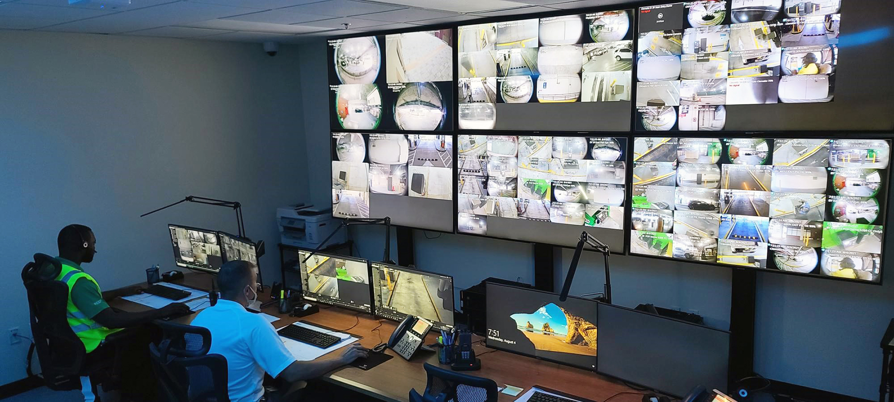 Wide shot of parking customer service center with multiple camera monitors