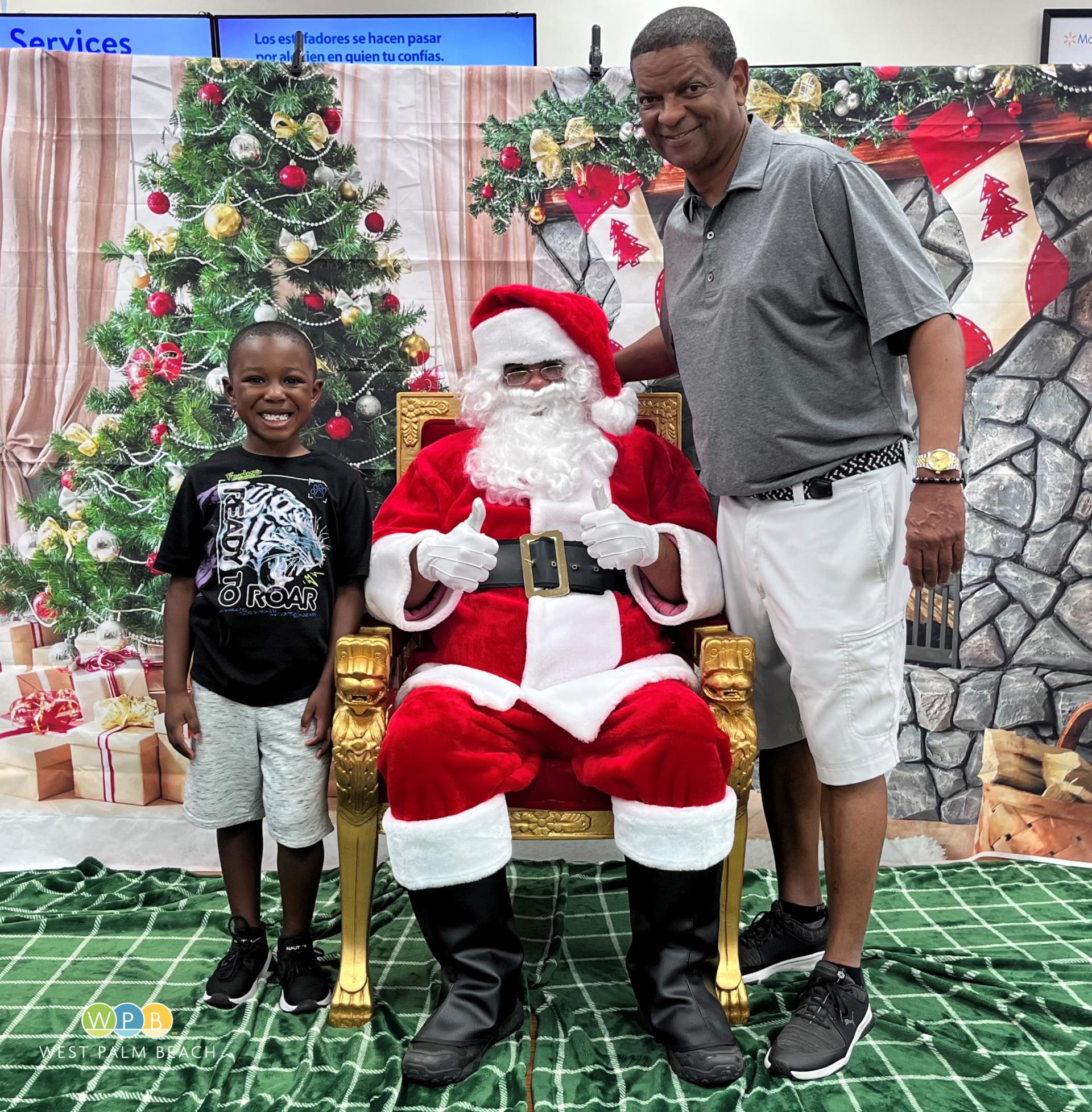 Police Chief Frank Adderley joins Santa and a young man